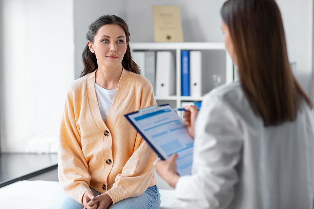 Doctor discusses stages of breast cancer with patient.