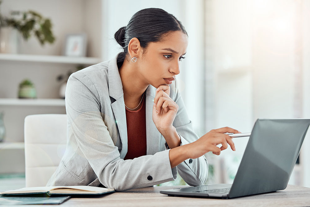Young woman reads article on computer about how to register as an organ donor.